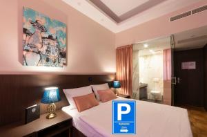 a bedroom with a bed with a sign on it at Hotel Center Ljubljana in Ljubljana