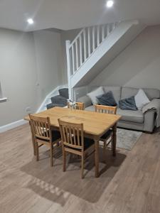 a wooden table and chairs in a living room at Reek View Accommodation in Westport