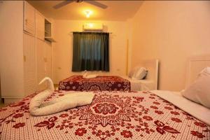 a hotel room with two beds and a window at mountain Luxor in Al Aqālitah +53 photos