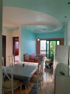 a living room with a table and chairs and a couch at El Basha Apartment sea View in Dumyāţ al Jadīdah