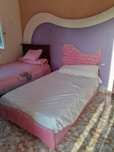 a bedroom with two beds and a head board at El Basha Apartment sea View in Dumyāţ al Jadīdah