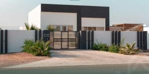 a gate in front of a house at شاليه روجا Roja Chalet in As Sulayf