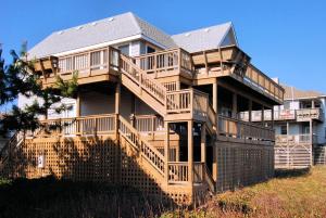 a large wooden house with a large deck at 2408 - Herring Gull in Duck