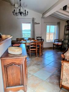 a kitchen and dining room with a table and chairs at Gite Thérèse in Montferrer