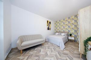 a bedroom with a bed and a couch at Residence Deluxe Benamino in Bran +14 photos