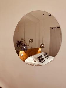 a mirror reflecting a bedroom with a bed in it at Celestine's Hideaway in Kamburugamuwa