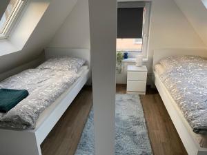 a bedroom with two beds and a window at R&A Unterkunft in Oberhausen