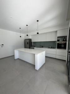a large kitchen with a white counter in a room at Casa Granadero Baigorria in Paganini