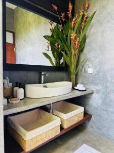 a bathroom with a sink and a mirror at Celestine's Hideaway in Kamburugamuwa +4 photos