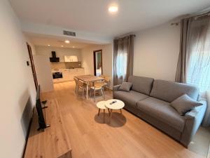 a living room with a couch and a table at Apartamentos Ésera in Santa Liestra y San Quílez