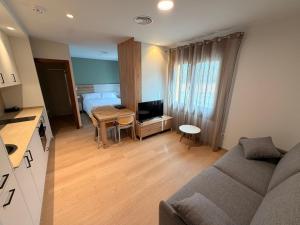 a small living room with a couch and a table at Apartamentos Ésera in Santa Liestra y San Quílez