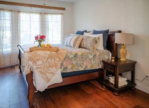 a bedroom with a bed and a table with flowers on it at The Old Crowe Inn Bed and Breakfast in Fruita