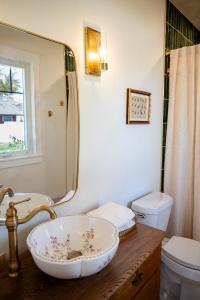 a bathroom with a bowl sink and a mirror at The Old Crowe Inn Bed and Breakfast in Fruita