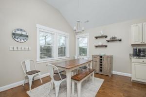 a dining room with a wooden table and chairs at 5176 - Sandy Bottoms in Kill Devil Hills