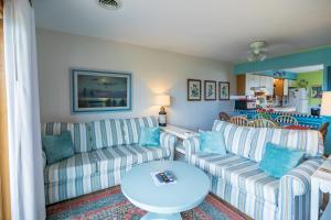 a living room with two couches and a table at 4204 - Outer Thanks in Duck