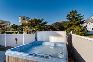 a hot tub sitting on top of a fence at 4052 - Mirth N Mist II in Duck