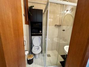 a bathroom with a toilet and a glass shower at Apto no Centro de Porto Alegre in Porto Alegre +20 photos
