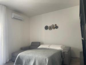 a bedroom with a bed and a clock on the wall at Tourgo Venice in Mestre