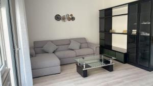 a living room with a couch and a glass coffee table at Tourgo Venice in Mestre