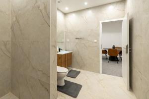 a bathroom with a toilet and a table at Beethoven Suite in Vienna +29 photos