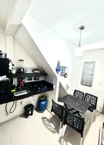 a kitchen with a stove and a table and chairs at Edifício AES Brasil in Cairu +25 photos