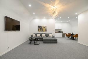 a living room with a couch and a television at Beethoven Suite in Vienna