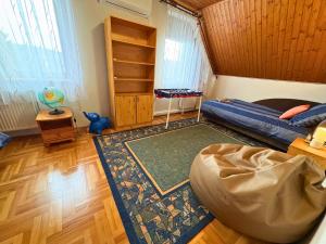 a bedroom with a bed and a rug at Rigódal Vendégház in Eger