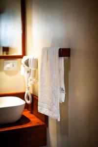 a bathroom with a white towel hanging on the wall at Fauna in Praia do Bananal +135 photos