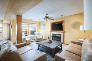 a living room with a couch and a fireplace at 5195 - Captain's Choice in Kill Devil Hills