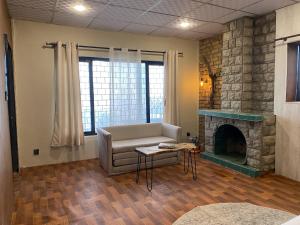 a living room with a couch and a fireplace at Acacia Homes in Kuldanna