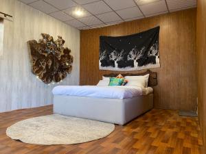 a bedroom with a white bed with a mirror on the wall at Acacia Homes in Kuldanna