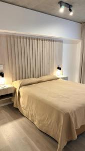 a bedroom with a large bed with two tables and two lamps at Almarena La Reserva UF 11 PB in Costa del Este +26 photos