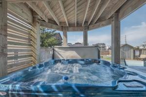 a hot tub on the patio of a house at 5468 - Mermaids' Lagoon in Nags Head