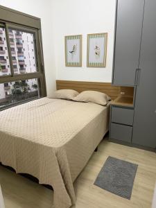 a bedroom with a bed and a window at Maison Perdizes 506 - Até 6 pessoas - Allianz Parque in São Paulo +7 photos