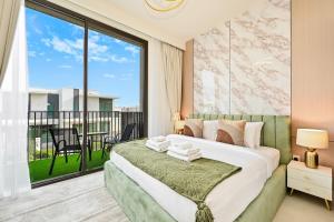 a bedroom with a bed and a large window at Warm and Cozy 4BR Villa with Pool Access in Dubai
