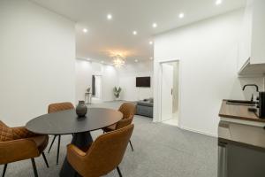 a kitchen and dining room with a table and chairs at Beethoven Suite in Vienna