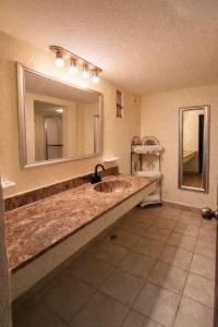 a bathroom with a sink and a large mirror at San Carlos de Reynosa in Reynosa +46 photos