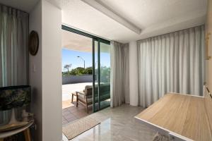 a dining room with a table and a view of a patio at Classic Coastal Escape - 1 Bedroom Ocean Views in Maroochydore +6 photos