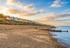 a long train on a pier next to the water at Sun, Sand & Sheppey The Ultimate Escape in Leysdown-on-Sea