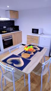 a table with plates of fruit on it in a kitchen at Le séjour in Champigny-sur-Marne