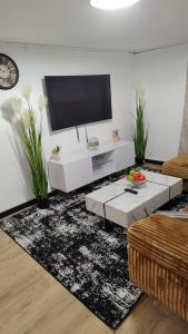 a living room with a flat screen tv on a wall at Le séjour in Champigny-sur-Marne