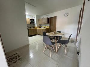 a kitchen and dining room with a table and chairs at Olivo House Casa Hotel in Envigado +13 photos