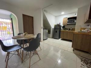 a kitchen with a table and chairs in a room at Olivo House Casa Hotel in Envigado