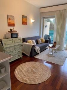 a living room with a couch and a table at Vale de Azereiros Apartamentos - Alojamento no Gerês in Geres