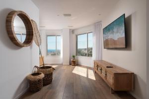 a living room with a table and a mirror at Kedem Eilat קדם אילת in Eilat +35 photos
