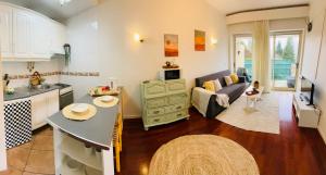 a kitchen and a living room with a couch at Vale de Azereiros Apartamentos - Alojamento no Gerês in Geres +19 photos