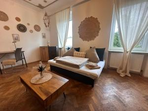 a living room with a couch and a table at Urban Spacious Bright Apartment with DanubeView in Linz