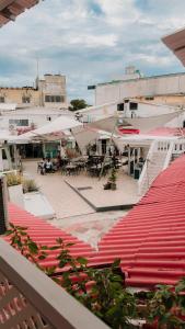 an outdoor patio with umbrellas and tables and chairs at Bless Hotel in San Andrés