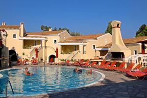a group of people in a swimming pool at a resort at Mediterranean Blue in Kavos