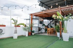 a patio with plants and lights on a building at HOTEL LA PALMERA DE ORO in Tarapoto
